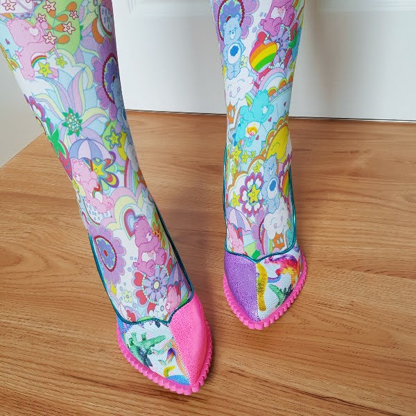 wearing colourful Care Bears tights with dinosaur print pointed toe shoes