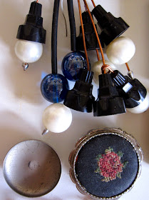 Collection of vintage plastic bits that could make modern miniature light fittings, plus a tiny embroidered box and a little round metal platter.
