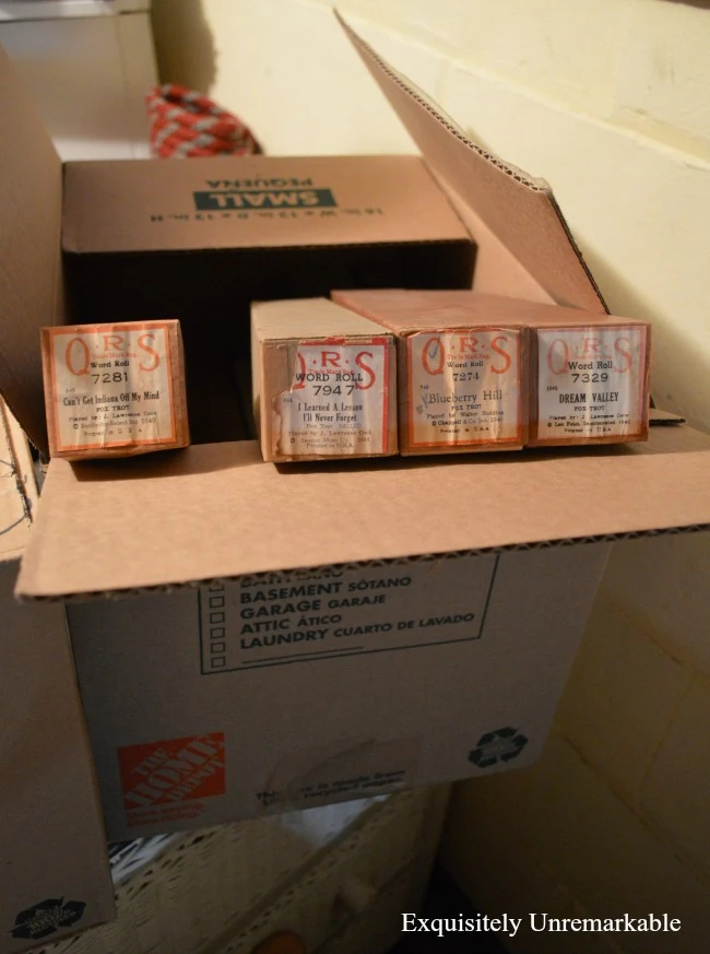 Vintage QRS Player Piano Rolls in a moving box