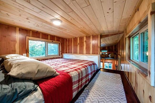 02-Master-Bedroom-Backcountry-Tiny-Homes-Basecamp-Tiny-House-on-Wheels-with-Rooftop-Balcony-www-designstack-co