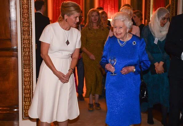 The Queen and Countess of Wessex hosted a reception Emilia Wickstead wool midi skirt, Victoria Beckham top, gold necklace