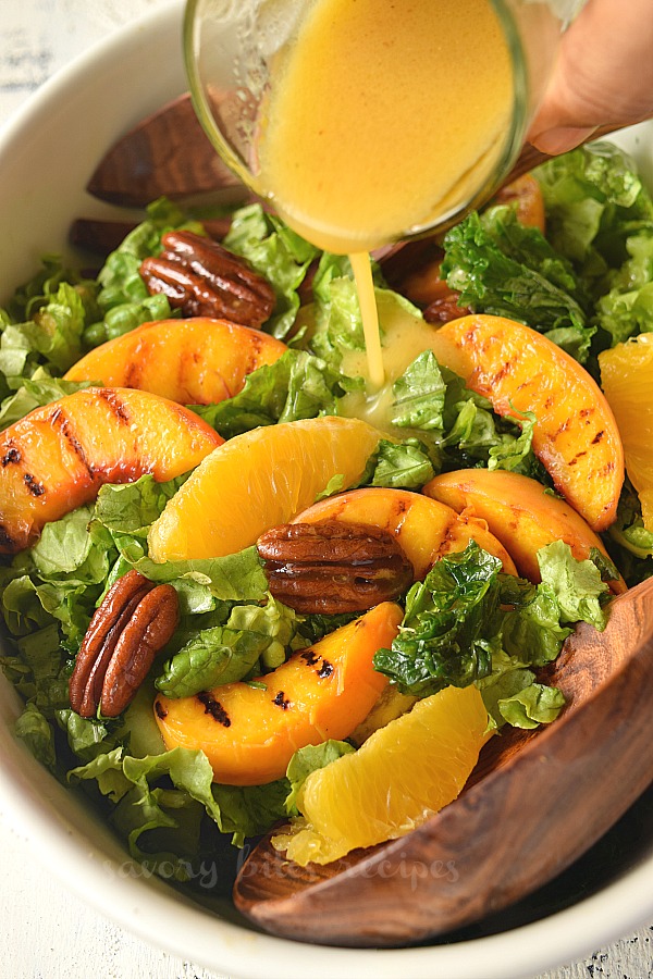 grilled peach salad in a bowl with honey vinaigrette