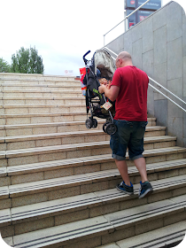 metro with a baby, carrying pushchair up steps