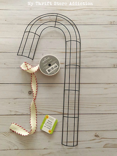 Run to the dollar store to grab a candy cane wire form so you can create one of these farmhouse style wreaths! DIY dollar store candy cane wreath