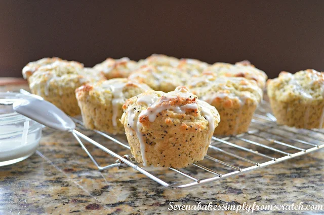 Lemon Poppy Seed Muffins drizzled with lemon glaze on a cooling rack.