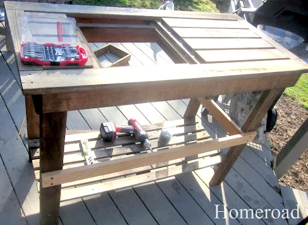 repairing pieces on an old potting table