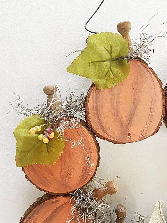 wood slice pumpkins with leaves and berries