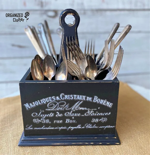 Photo of upcycled silverware caddy with vintage silverware inside.