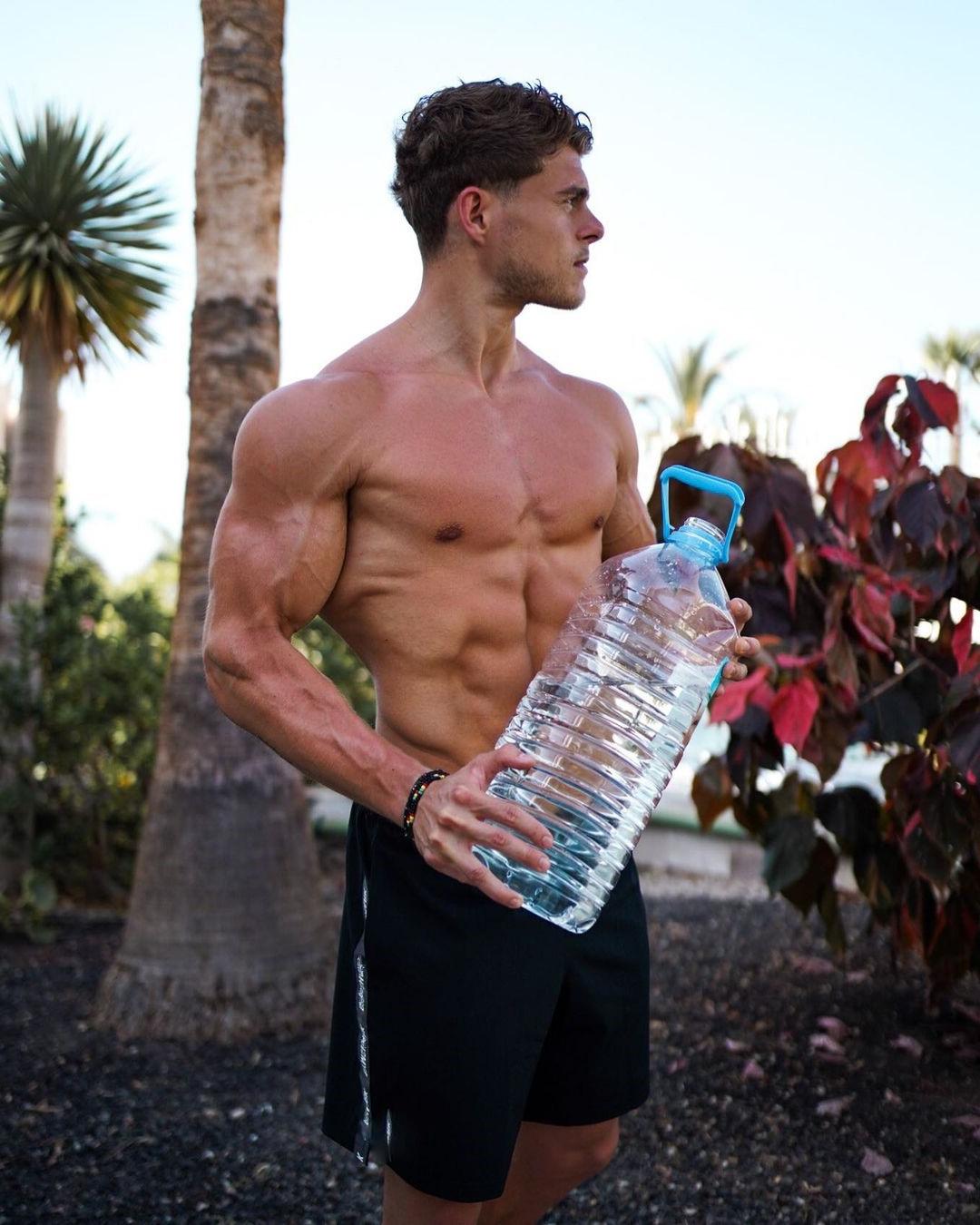 masculine-shirtless-ripped-man-richard-duchon-water-gallon-abs-biceps