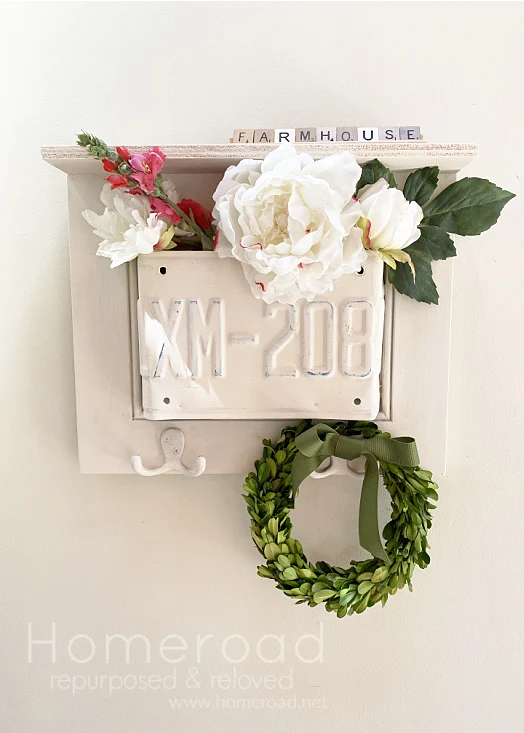 license plate shelf with wreath and flowers