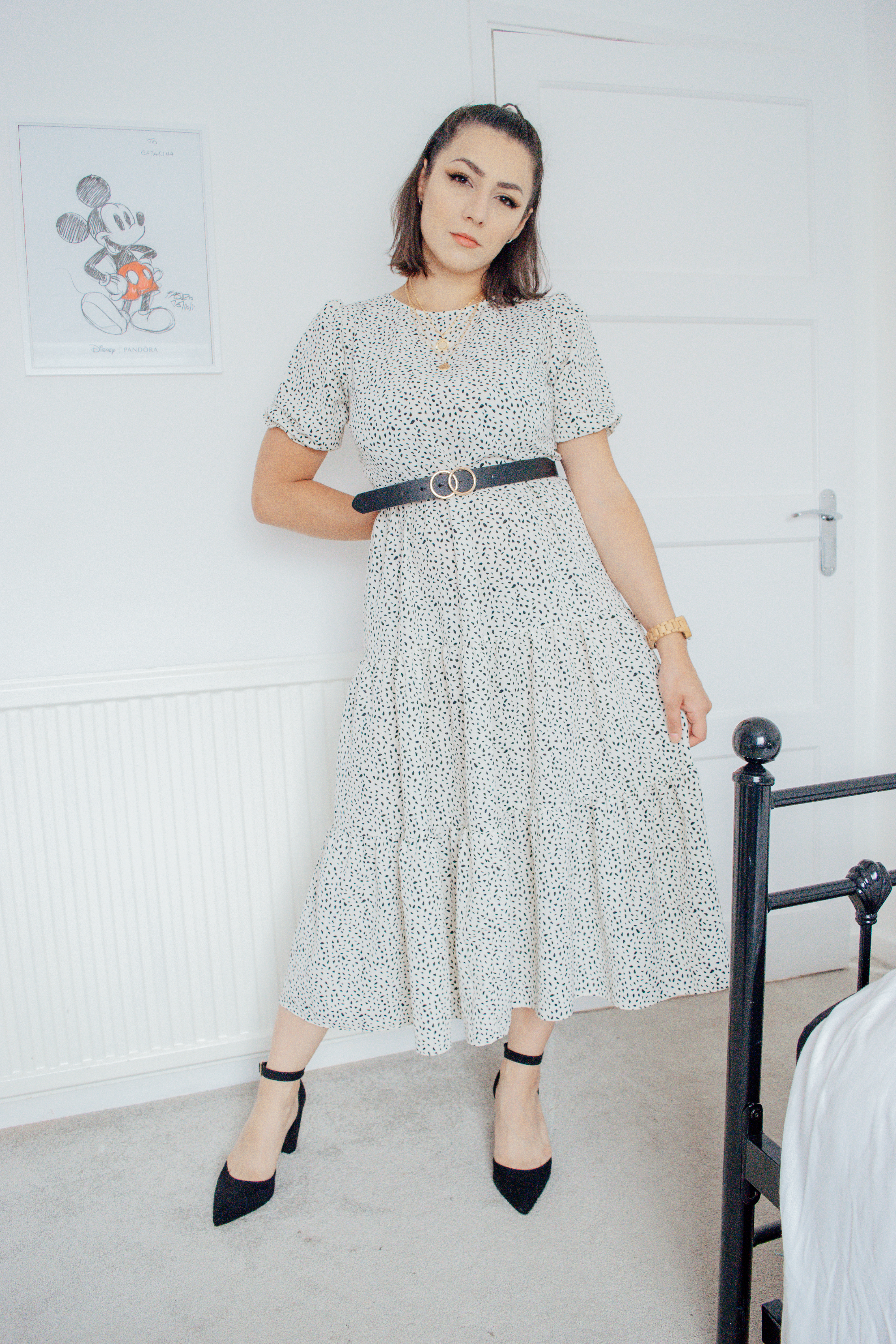 Girl wearing a white spotted midi dress