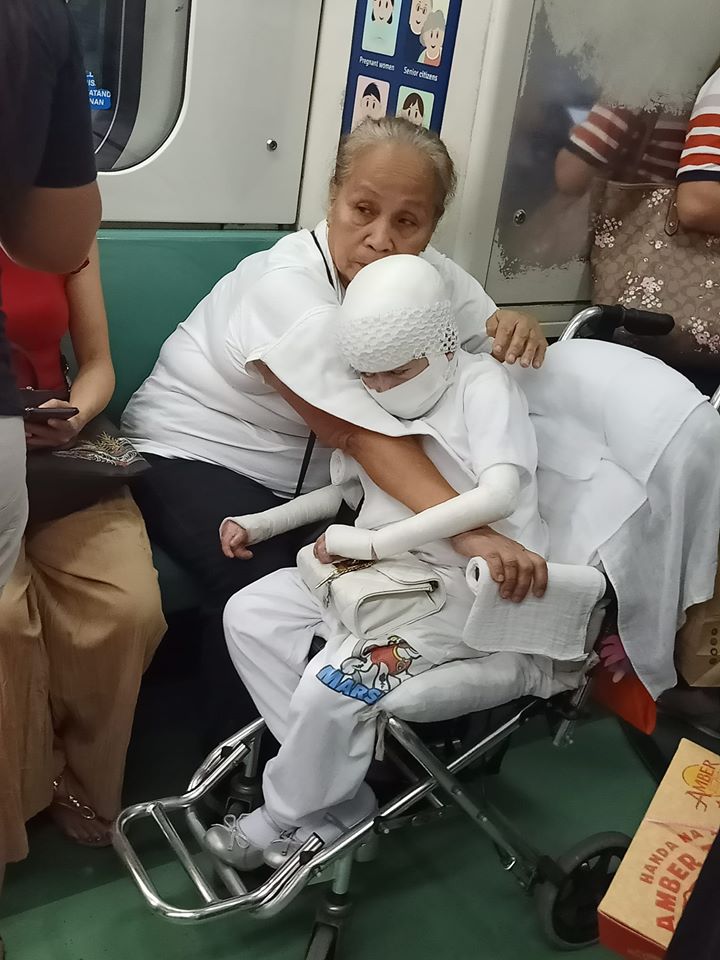 Lola rides LRT with wheelchairbound child wrapped in bandages