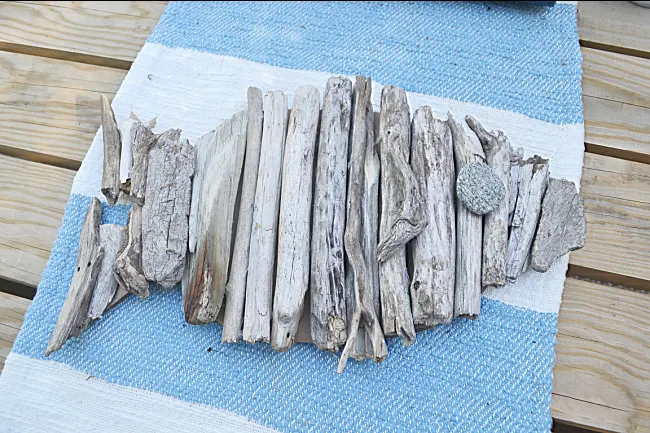 driftwood fish on a blue and white table runner