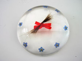 Lock of loved ones hair and forget me not flower paperweight