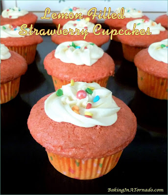 Lemon Filled Strawberry Cupcakes, features spring flavors. Fluffy strawberry cupcakes, filled and topped with lemon frosting. | Recipe developed by www.BakingInATornado.com | #recipe #cake