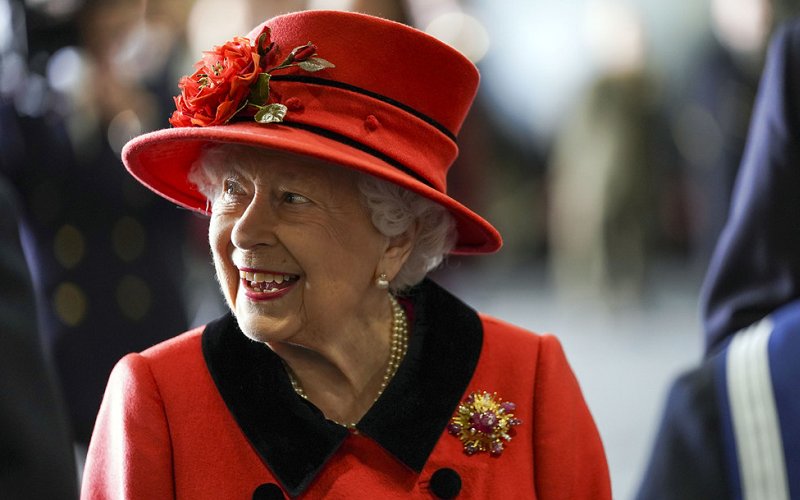 Queen Elizabeth wore a red coat, gold diamond brooch. HMS Queen Elizabeth and sister aircraft carrier HMS Prince of Wales