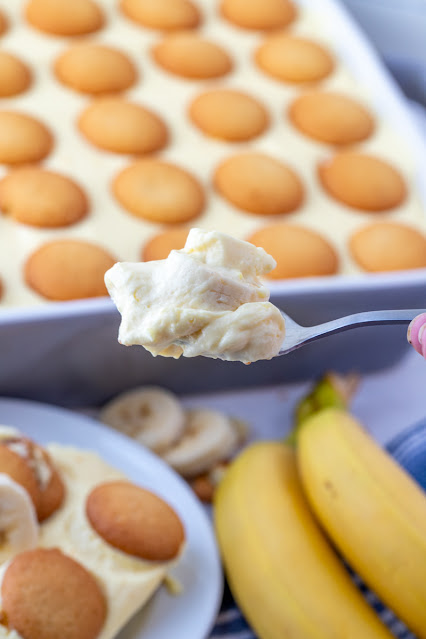 banana pudding on a spoon with the pan in the background