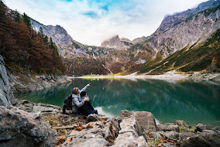 people at the bank of lake