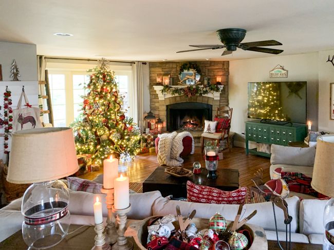 Family room with stone fireplace and classic plaid Christmas decor -www.goldenboysandme.com