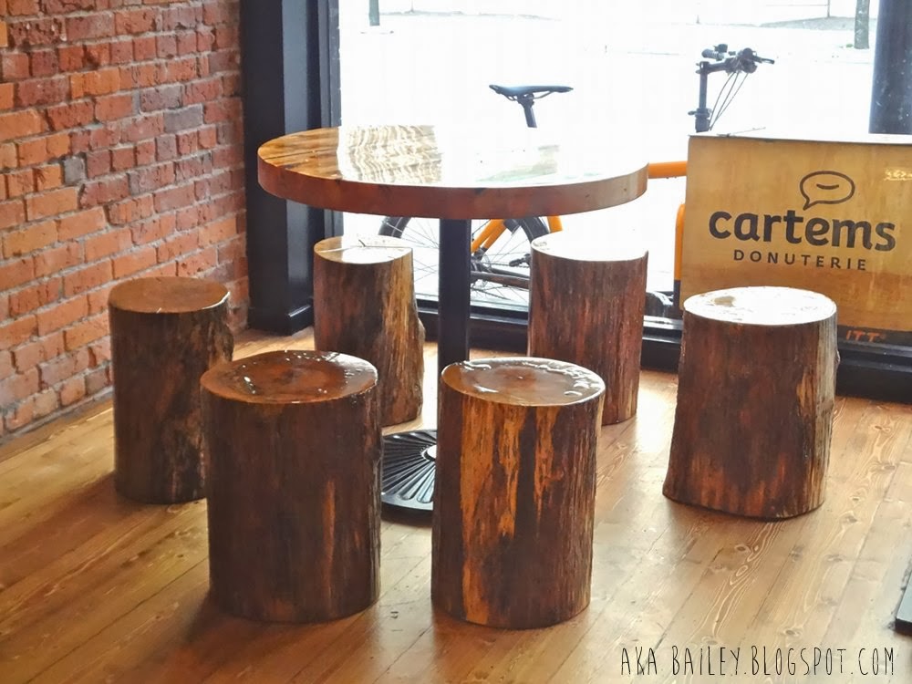 Table with log stools inside Cartems Donuterie in Vancouver