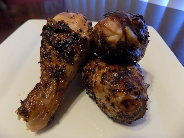 This is a plate of 3 grilled barbecue chicken legs.