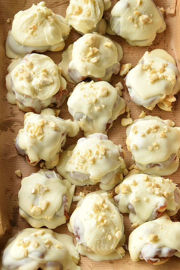 a close look of a tray with white chocolate caramel cashew clusters