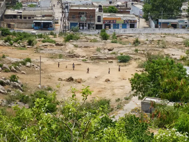 Views of Hyderabad India from Falaknuma Palace: children playing cricket