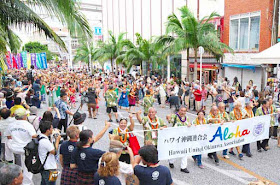 Okinawans from Hawaii marching on Kokusai Street, Naha