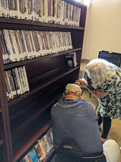 Mr. J and Brenda installing shelves