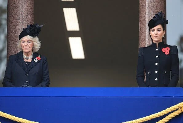 Kate Middleton wore a bespoke black military coat by Alexander McQueen, and a Philip Treacy hat. Queen's diamond and pearl earrings