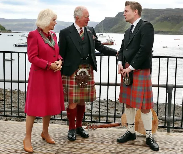 Duchess wore a waist-cinching red coat with a tartan lapel and tan heels. Camilla added a sapphire and diamond brooch