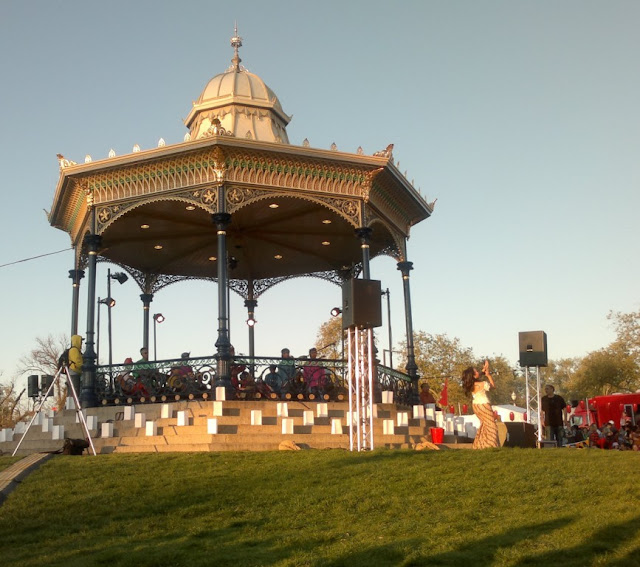 Adelaide's Elder Park Rotunda viewed from the Torrens River side.  Inside the rotunda is a 7 piece band and the lead singer is dancing and singing on the lawn in front of the rotunda which is on the right hand side in this photograph.