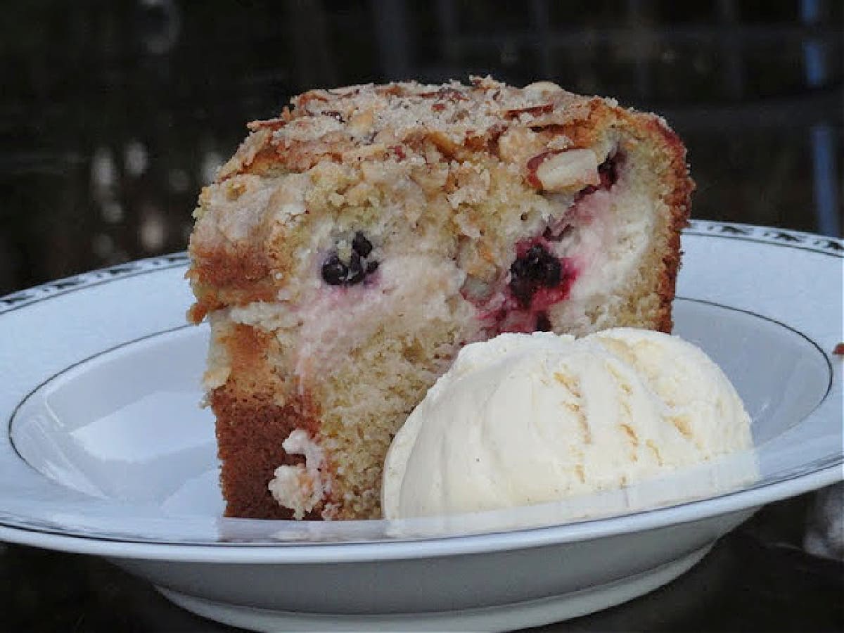 A slice of Blackberry Cream Cheese Coffee Cake on a white plate.