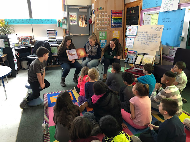 high schoolers reading to third graders