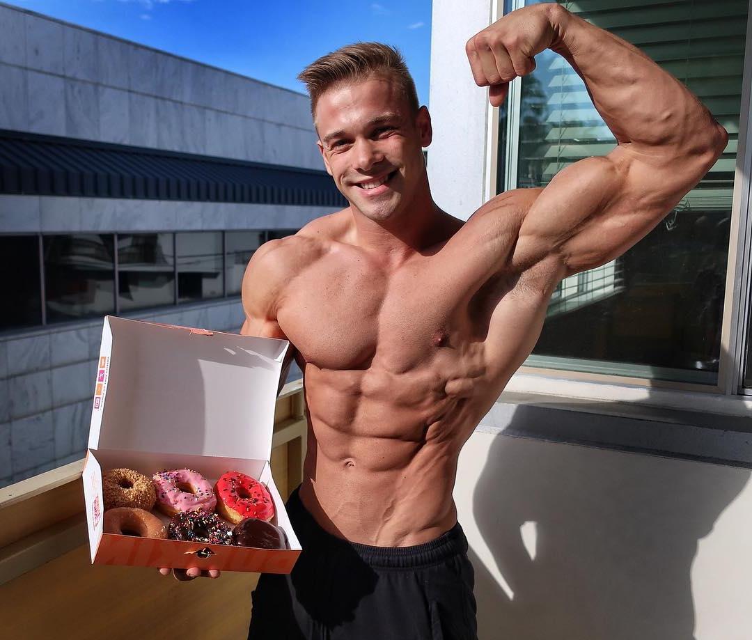 cute-blond-daddy-offering-beautiful-donuts-while-shirtlessly-flexing-biceps