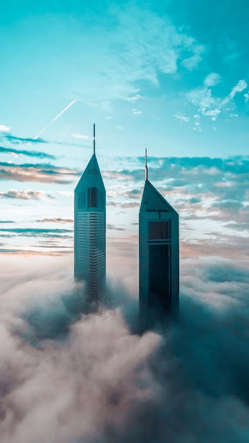 Wallpaper skyscrapers above the clouds