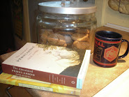 Some of my favourite things.  Tea, Arsenal (mug), ginger cookies in the jar, and books.