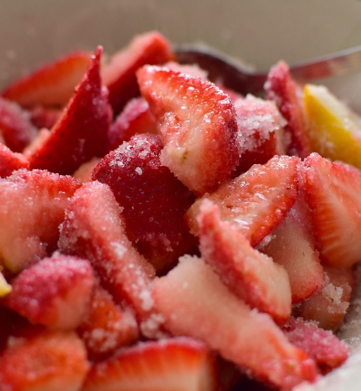 Fresas frescas cortadas en trozos, cubiertas en azúcar y jugo de limón, para maceración