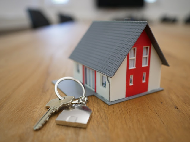 Small cardboard house, next to a set of keys