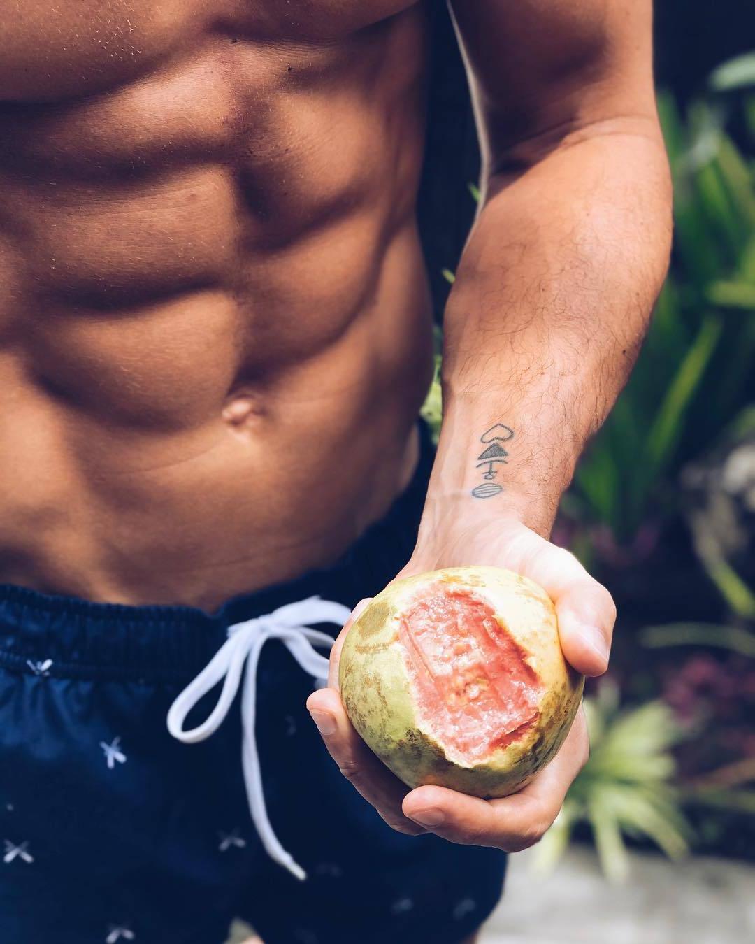 anonymous-sixpack-abs-male-youngster-eating-unknown-tropical-fruit