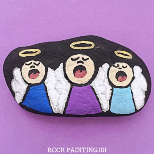 Christmas painted rock with cute little angel carolers