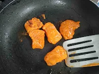 Flipping fish pieces on Tawa or pan for fish tikka recipe