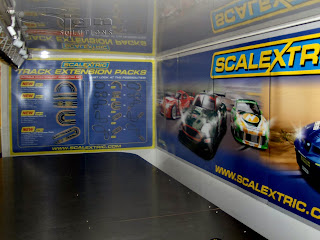 Photograph of the inside of the Hornby lorry with full colour printed boards attached to the walls inside. The graphics are of racing cars.