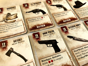 A selection of equipment cards from The Walking Dead: All Out War miniatures game