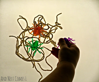 Close up of spiderweb building on the light table from And Next Comes L