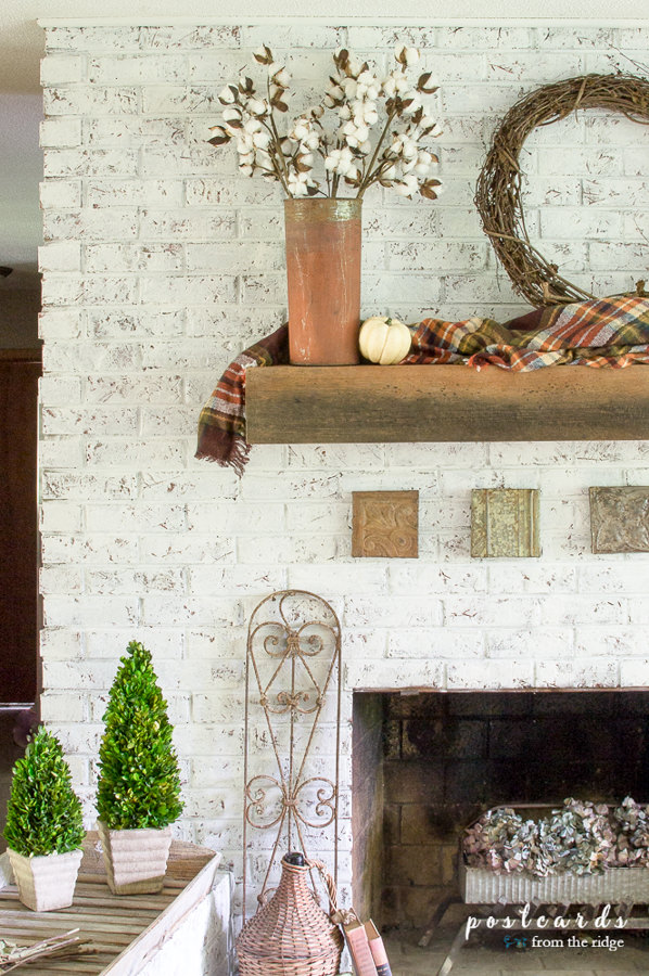 fall mantel with plaid blanket scarf and rustic metal, white painted brick fireplace