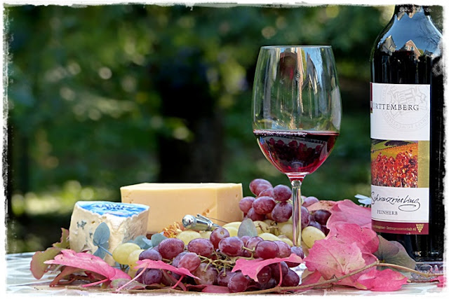spontaneous easy lunch of cheese, bread, wine, fruit, nuts and accompaniments
