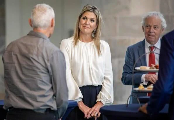 Queen Maxima's outfit is by Belgian fashion house Natan. Queen Maxima wore a silk blouse and wide leg trousers from Natan