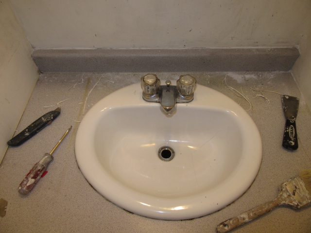 removing old caulk around bathroom vanity.