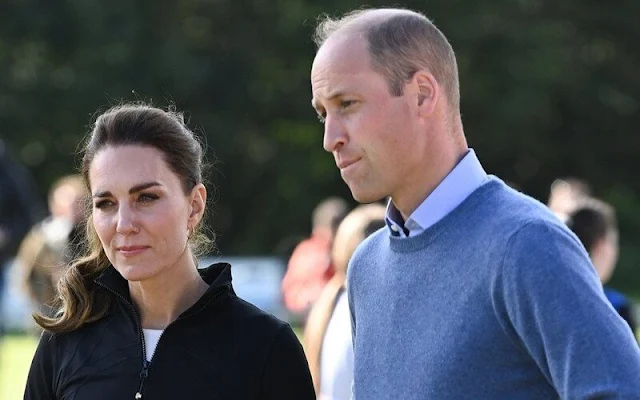 Kate Middleton wore a purple suit by Emilia Wickstead. Emmy London Josie pumps and Jaeger quilted bag